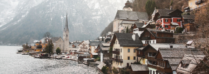 Small town next to a lake with mountains in the background