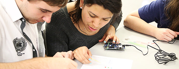 students working with a professor