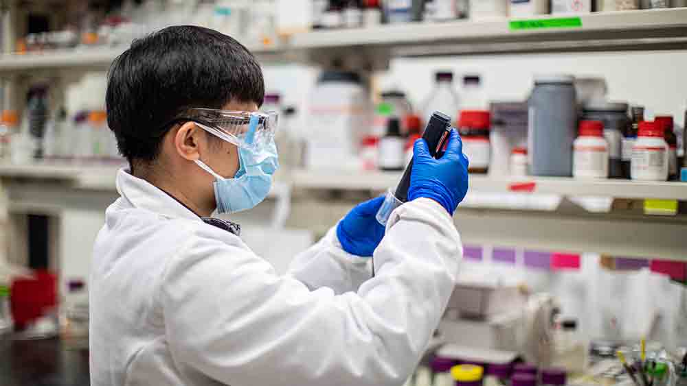 Student examining machinery