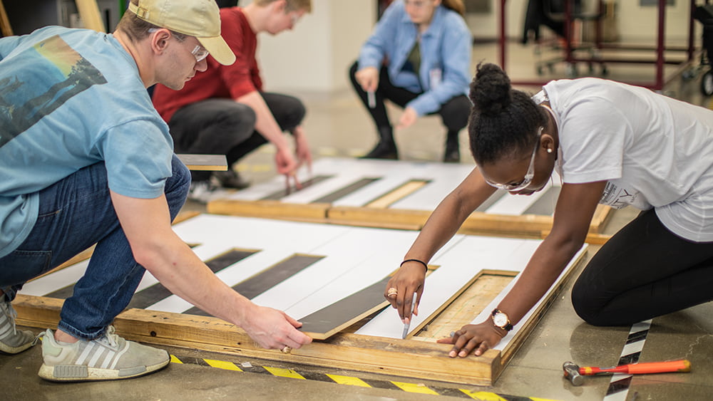 Group members working on the piano