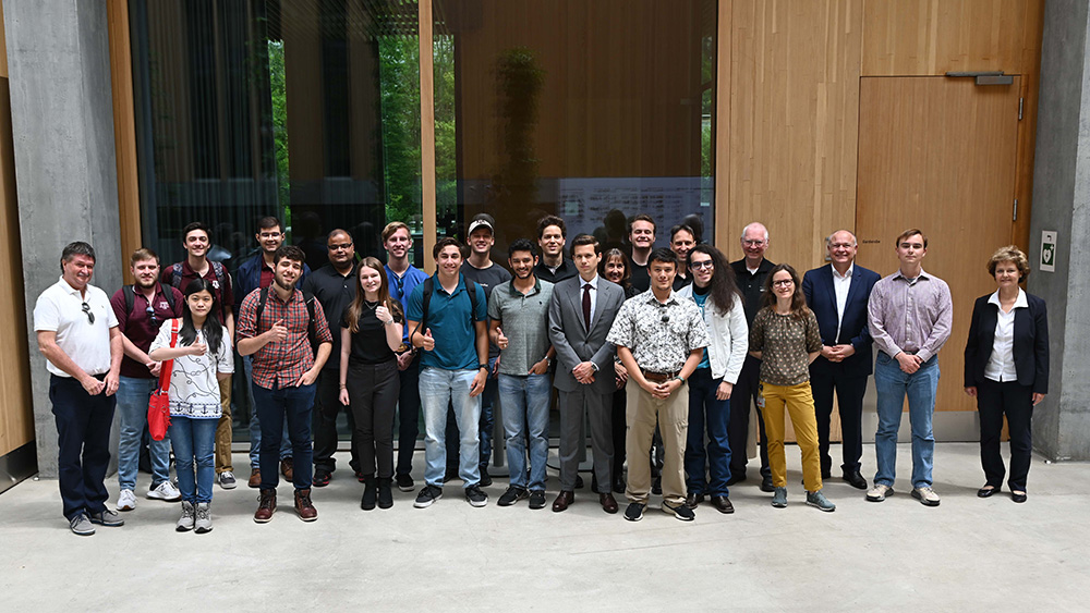 Students stand in front of the Swiss Federal Office of Energy in Bern, Switzerland