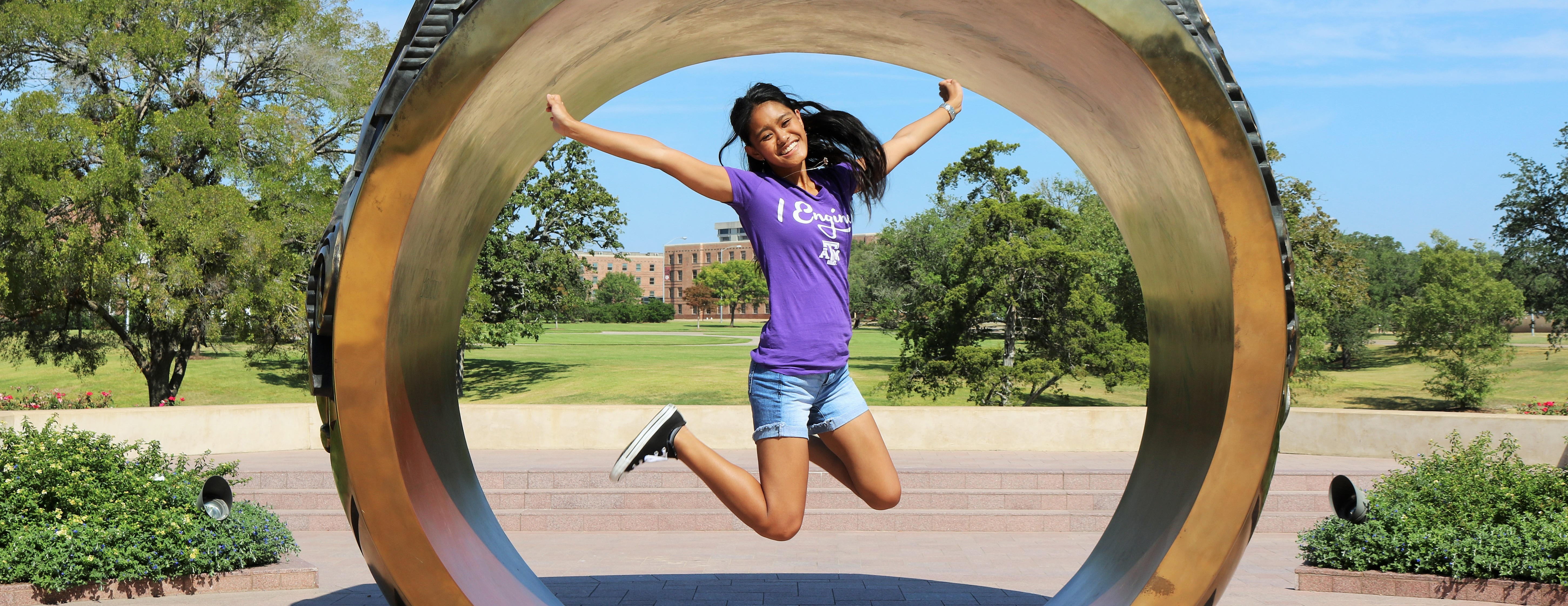 Student jumping infront of Aggie ring