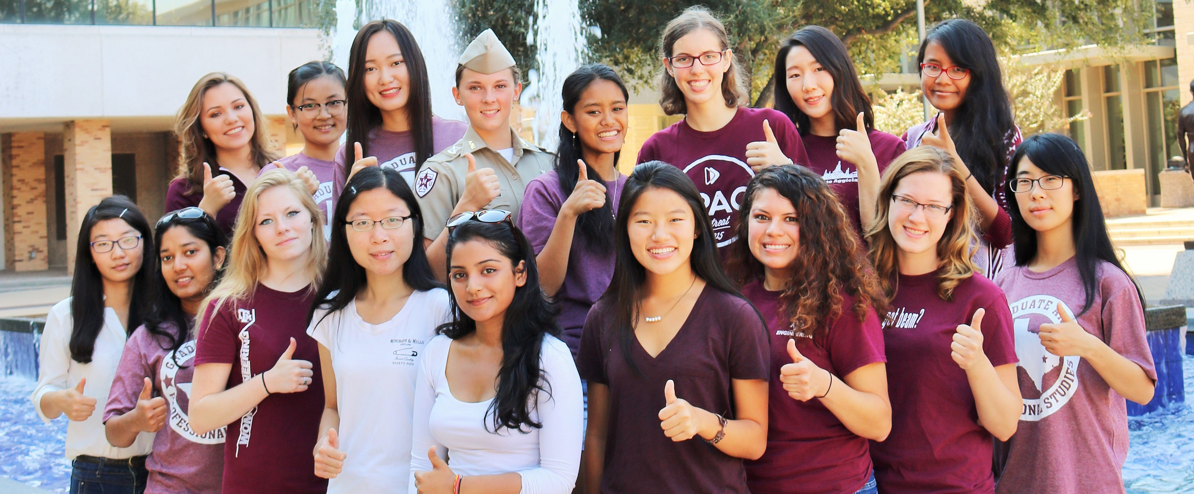 Women in Engineering members standing in front of fountain